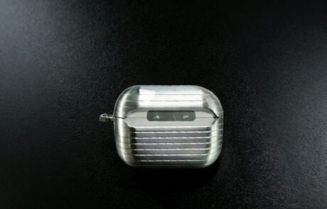 This Custom Aluminum Electronics Housing is a precision CNC machined earphone case featuring a distinct ribbed texture for enhanced grip and durability.