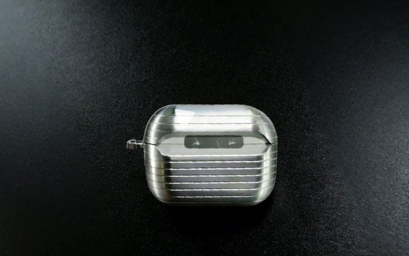 This Custom Aluminum Electronics Housing is a precision CNC machined earphone case featuring a distinct ribbed texture for enhanced grip and durability.