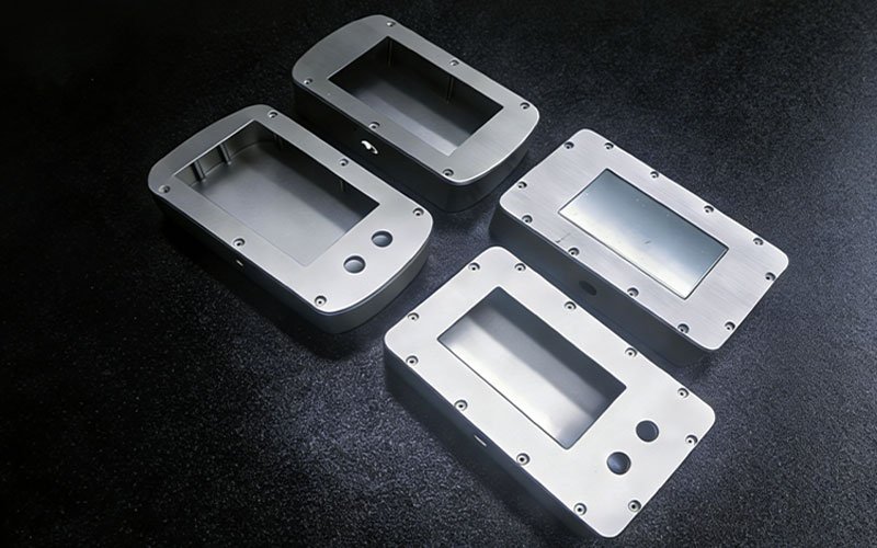 Custom aluminum cnc machining parts serving as electronic device enclosures with screen cutouts and bead blasted finish.