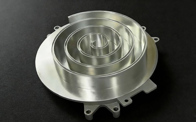 Precision CNC machined aluminum fixed scroll for compressors, featuring complex involute spiral walls and mounting lugs.