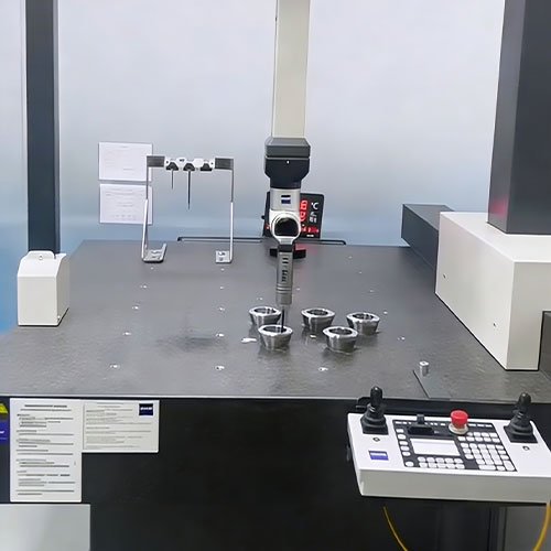 zeiss-cmm-inspection-titanium-machined-parts Zeiss CMM probe inspecting the internal bore of a custom titanium CNC machined part for aerospace precision.