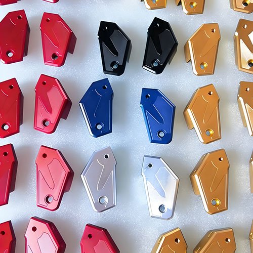 CNC machined aluminum parts with various anodized colors: red, black, blue, gold, and silver, demonstrating our anodizing color options for custom components.