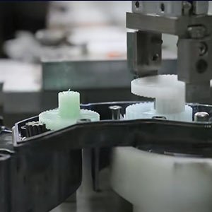 Assembly testing of CNC machined Delrin gears inside an automotive actuator housing, designed for low noise and high durability.