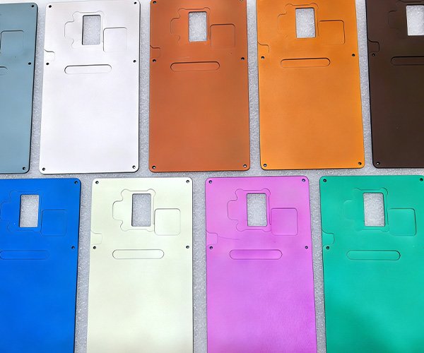The Perfect Combination: Bead Blasting & Anodizing Collection of CNC machined aluminum plates showing matte anodized finishes in blue, gold, orange, purple, and green. Parts were bead blasted prior to anodizing to remove tool marks.