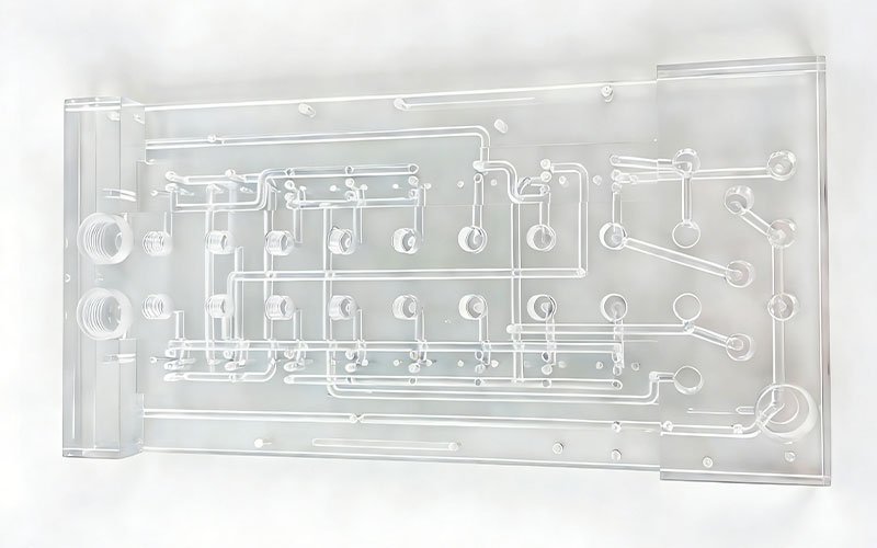 Acrylic Fluidic Manifold A multi-channel manifold machined from PMMA. The high optical clarity allows for visual inspection of flow paths and internal mixing chambers.