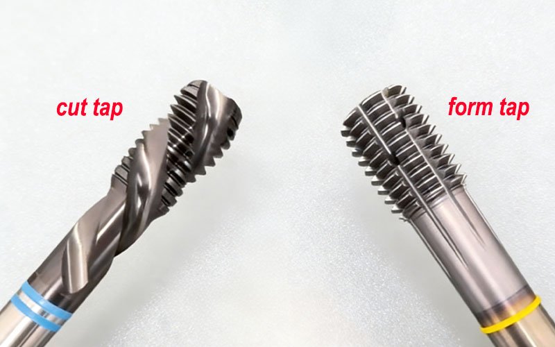 A comparison between a spiral flute cut tap (left) and a TiN-coated form tap (right) used for threading in CNC machined aluminum parts.