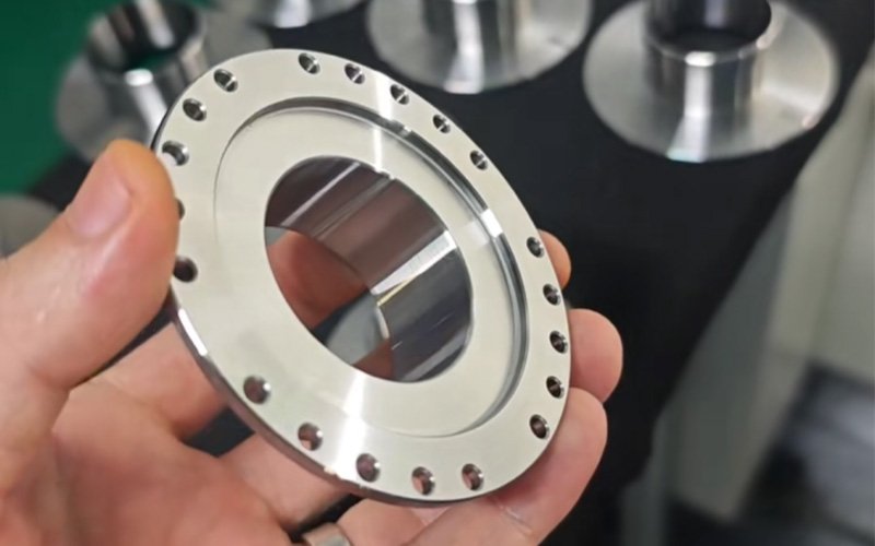 Close-up of a high-precision CNC turned flexspline blank for a robotic harmonic drive, showcasing the ultra-thin wall and mounting holes before the final gear cutting process.