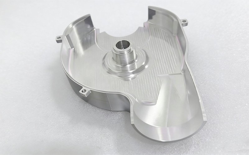 CNC machined aluminum 6061 housing cover showing deep internal pocketing, thin walls, and mounting tabs.