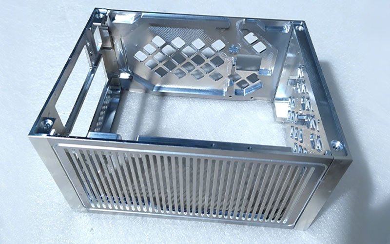 Custom CNC machined Aluminum 6061 chassis featuring deep pocket milling and long parallel ventilation slots.