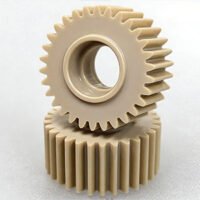Custom CNC Machined PEEK Gears Precision CNC machined natural PEEK spur gears showcasing tight tolerance gear teeth and smooth surface finish.