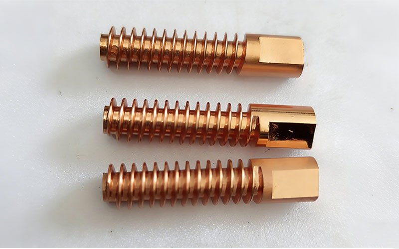Three precision-machined copper thread electrodes with helical fins and hex flat heads, showcasing a bright surface finish.