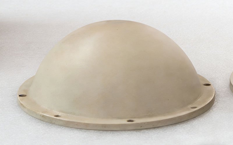 A completed PEEK GF30 dome part showing improved dimensional stability and minimized deformation after being removed from the epoxy fixture.