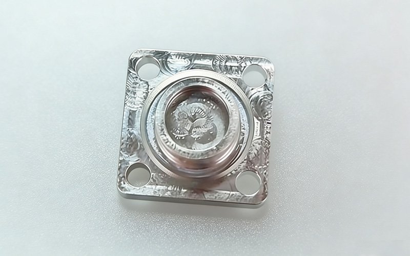 Custom CNC machined magnesium alloy part for robotics, featuring precise central bore and standard as-machined finish.