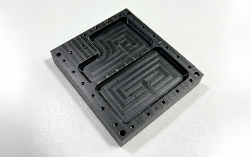 CNC milled black POM custom non-standard part with dual rectangular cavities and perimeter screw holes for automation equipment