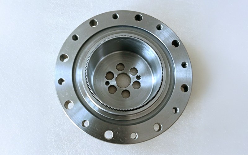 Precision ground harmonic drive circular spline showing internal gear tooth profile and flange bolt hole pattern
