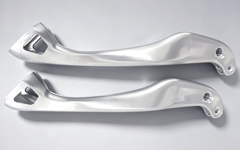 Matched pair of CNC machined 7075-T6 aluminum robot dog leg links with free-form curved bodies, as-machined finish