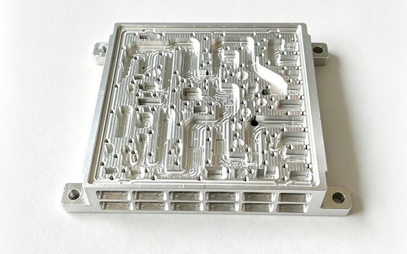 Custom aluminum 4047 waveguide housing with a dense micro-channel network and sharp unchambered edges
