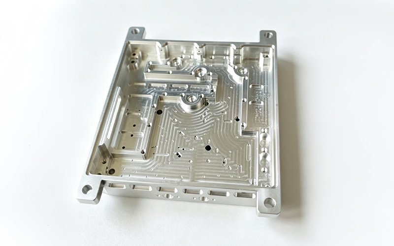 Mounting side of a custom aluminum 4047 waveguide housing with bosses and corner mounting holes