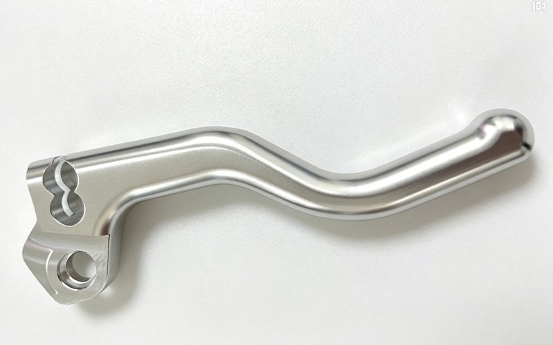 Custom CNC machined motorcycle brake lever arm in polished aluminum with a splined pivot bore