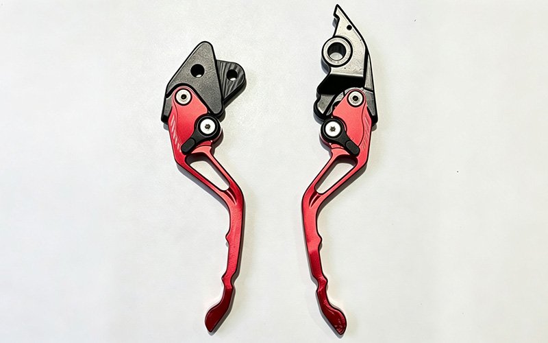 Custom CNC machined short adjustable motorcycle brake and clutch levers in red and blue anodized finishes