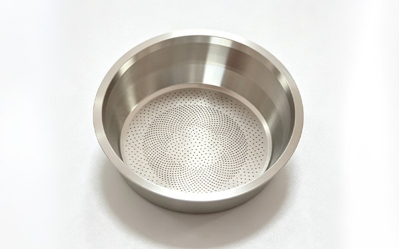 Custom CNC machined stainless steel coffee filter basket with a laser-cut precision hole pattern