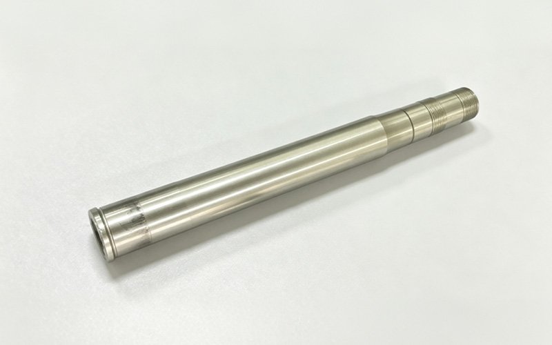 Custom CNC turned titanium TC4 motorcycle steering stem with a stepped shaft and threaded end
