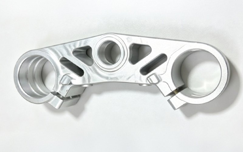 Custom bottom triple clamp with pinch slots, machined for Ducati fork fitment on a Yamaha MT09