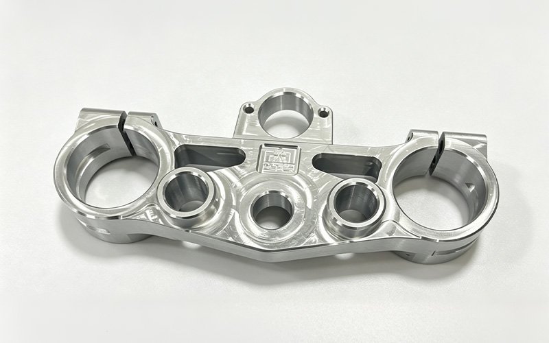 Custom motorcycle triple clamp machined from 7075-T6 aluminum with